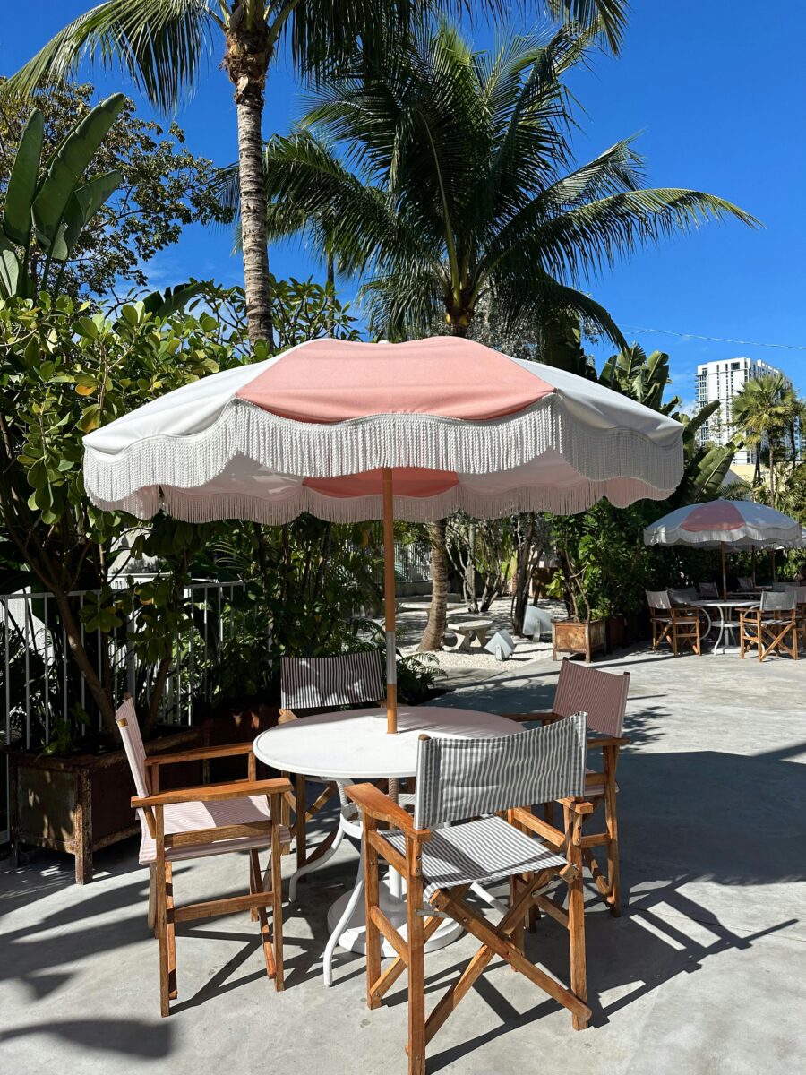 Cadre de café extérieur avec parasol déporté et ambiance tropicale